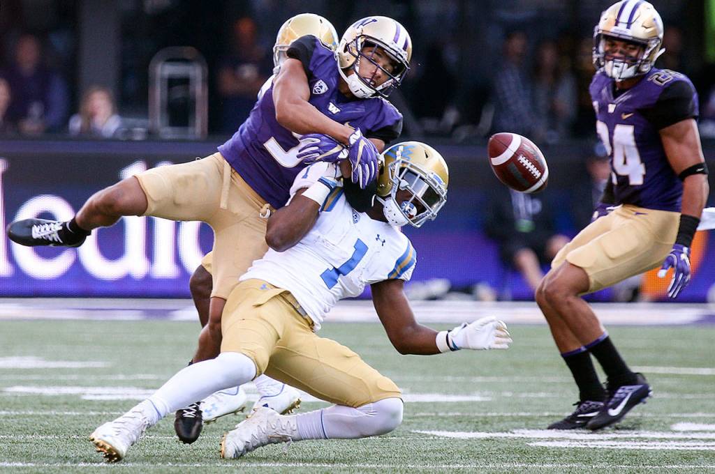 Washingtons Myles Bryant breaks up a pass intended for UCLAs Soso Jamabo with teammate Ezekiel Turner looking on during a game Oct. 28, 2017, at Husky Stadium. Washington won 44-23. (Kevin Clark / The Herald)