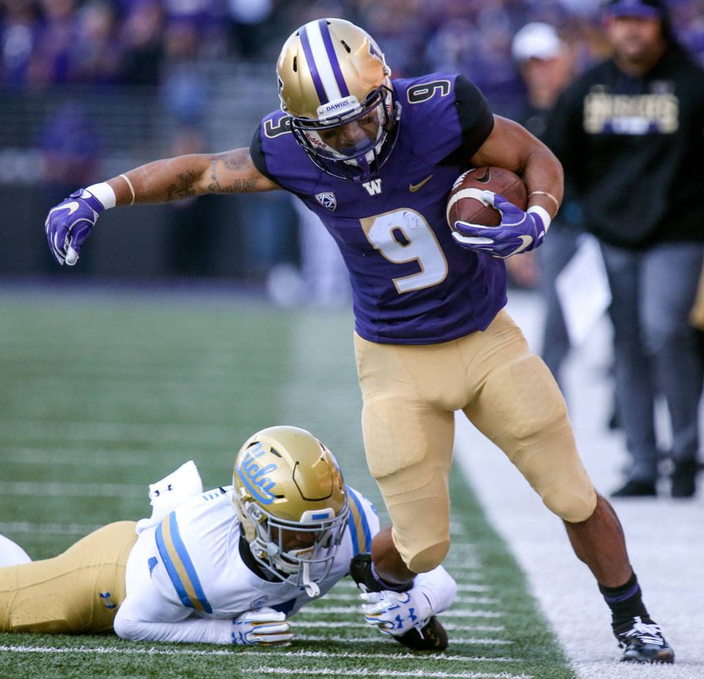 UCLAs Jaleel Wadood makes a shoe-string tackle on Washingtons Myles Gaskin on Oct. 28, 2017, at Husky Stadium . Washington won 44-23. (Kevin Clark / The Herald)