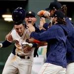 The Houston Astros celebrate after Alex Bregman (left) hit a game-winning single in the 10th inning of Game 5 of the World Series on Sunday night in Houston. (AP Photo/Matt Slocum)
