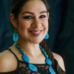 Viviana Rizo, owner of Seeds and Stones Handmade Jewelry, shows off a necklace made with tagua nuts at the Fall Home Show in Xfinity Arena on Oct. 27. (Andy Bronson / The Herald)