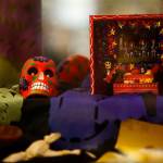 Julieta Altamirano-Crosby set up a display Tuesday about Dia de los Muertos (Day of the Dead) at the Lynnwood Library. (Dan Bates / The Herald)