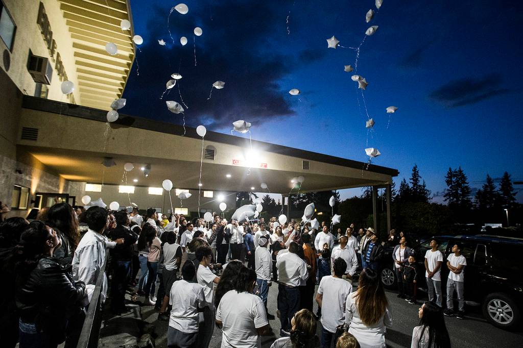 Family and friends of slain teenager David Sandoval release white balloons following a service at Bible Baptist Church on West Casino Road in Everett on Oct. 10 to honor his life. (Ian Terry / Herald file)