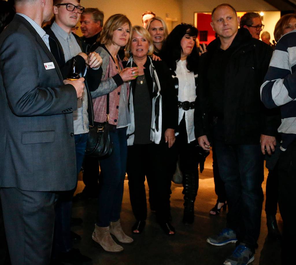 Everett mayoral candidate Judy Tuohy (center) watches with Everett City Council member Brenda Stonecipher (center left) as initial election results come in at Schack Art Center in downtown Everett on Tuesday. (Ian Terry / The Herald)