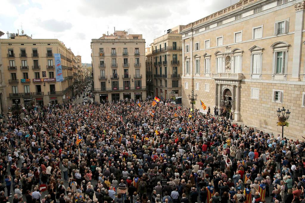 Thousands of people rally outside the regional presidential palace in Sant Jaume Square to show their support for those appearing in court, in Barcelona, Spain, on Thursday. (AP Photo/Manu Fernandez)