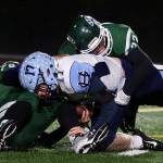 Edmonds-Woodways Jacob Kitchen (left) and Jack Tillman sack Gig Harbors Ryan Baerg during a Week 10 playoff game on Nov. 3, 2017, at Edmonds Stadium. (Kevin Clark / The Herald)
