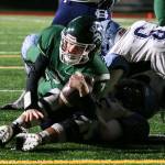Edmonds-Woodways Reilly Chappell rolls over Gig Harbors Brenden Rivera for a touchdown during a Week 10 playoff game on Nov. 3, 2017, at Edmonds Stadium. (Kevin Clark / The Herald)