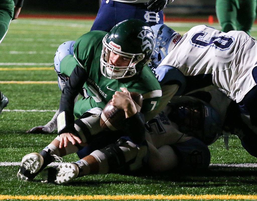 Edmonds-Woodways Reilly Chappell rolls over Gig Harbors Brenden Rivera for a touchdown during a Week 10 playoff game on Nov. 3, 2017, at Edmonds Stadium. (Kevin Clark / The Herald)