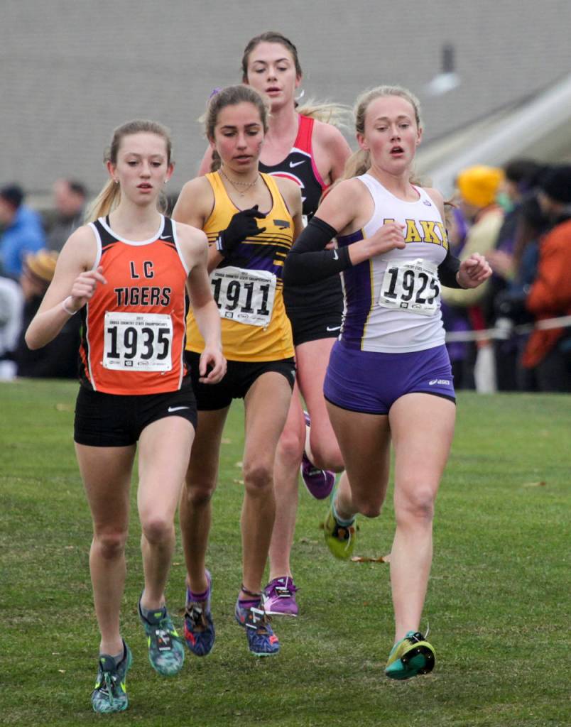 Lake Stevens Taylor Roe (right) leads the girls 4A pack during the state cross country championships on Nov. 4, 2017, at Sun Willows Golf Course in Pasco. (Ian Terry / The Herald)