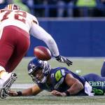 Seahawks quarterback Russell Wilson is shoe string sacked by Redskins Terrell McClain (not pictured) as Redskins Anthony Lanier III closes Sunday afternoon at CenturyLink Field in Seattle on November 5, 2017. Redskins won 17-14. (Kevin Clark / The Herald)