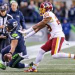 Seahawks quarterback Russell Wilson reaches for a first down as Redskins Kendall Fuller pushes him out of bounds Sunday afternoon at CenturyLink Field in Seattle on November 5, 2017. Redskins won 17-14. (Kevin Clark / The Herald)