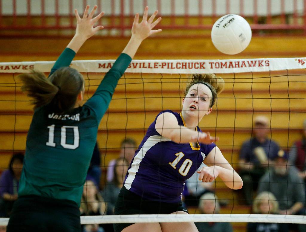 Lake Stevens Anna Saack (right) spikes the ball past Jacksons Lauren Demoulin during the 4A District 1 championship game at Marysville Pilchuck High School on Nov. 2. (Ian Terry / The Herald)