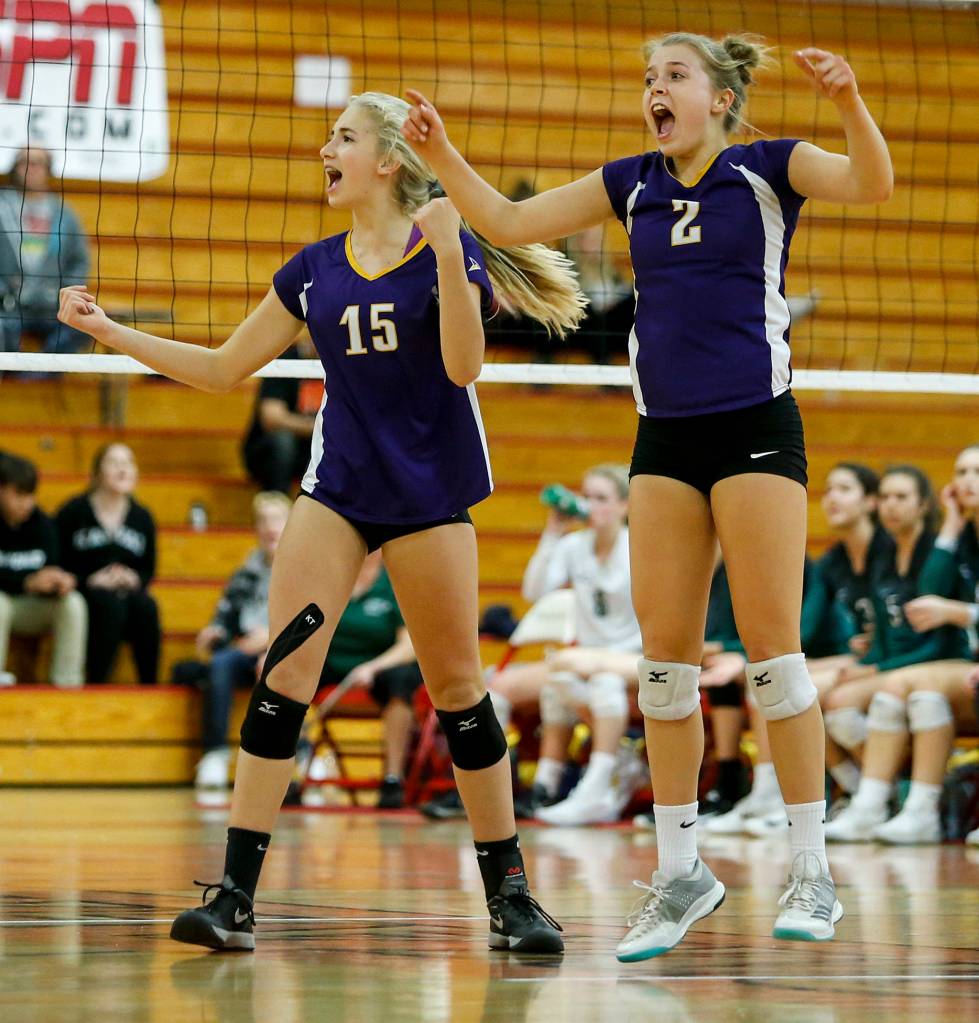 Lake Stevens Samaya Morin (15) and Lillian Eason (2) celebrate a point during the 4A District 1 championship game against Jackson at Marysville Pilchuck High School on Nov. 2. (Ian Terry / The Herald)