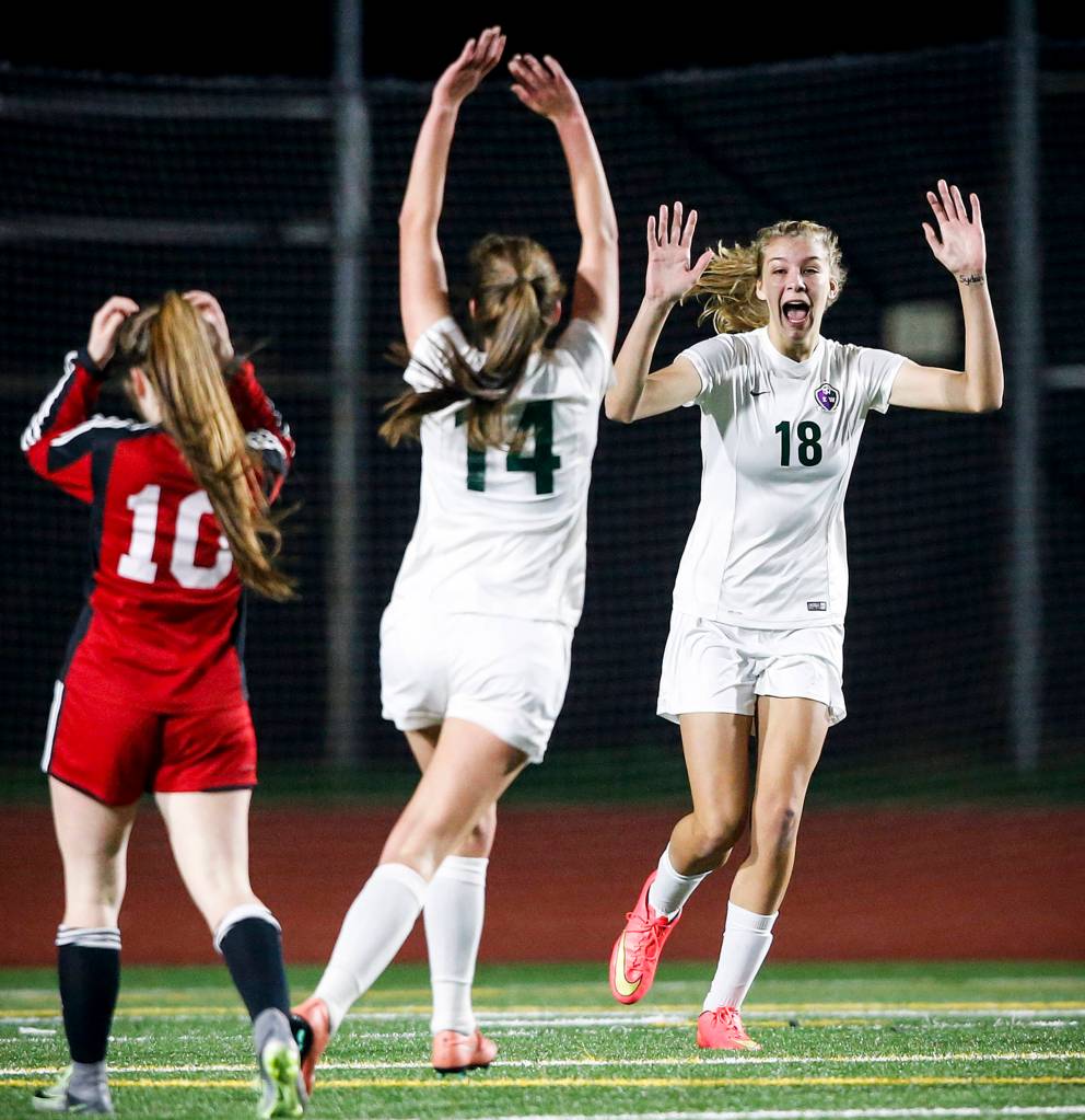 Edmonds-Woodways Kyra Hicks (18) celebrates her goal with teammate Ingrid Fosberg (14) during a game against Marysville-Pilchuck at Edmonds Stadium on Oct. 31. (Ian Terry / The Herald)