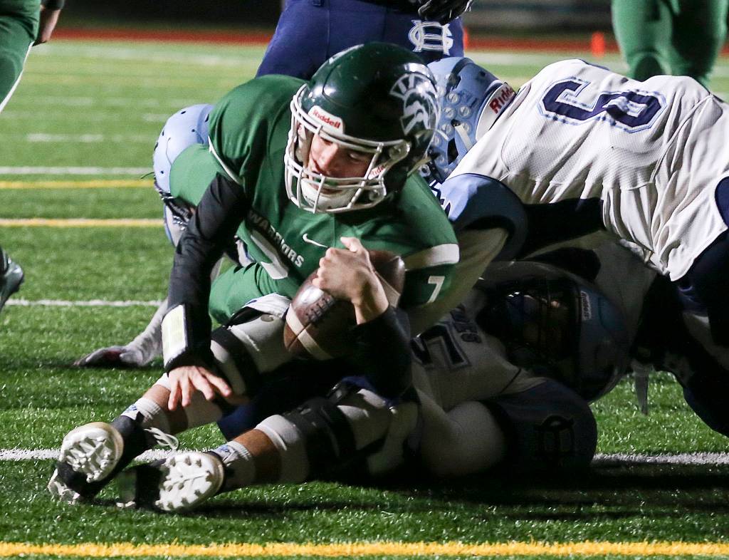 Edmonds-Woodways Reilly Chappell rolls over Gig Harbors Brenden Rivera for a touchdown at Edmonds Stadium in Edmonds on Nov. 3. (Kevin Clark / The Herald)