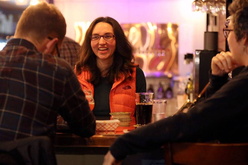 Co-owner Danielle Lothrop (center) talks with customers. When they decided to open a bottleshop, the Lothrops immediately decided to locate it in downtown Everett. (Kevin Clark / The Herald)