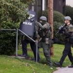 Officers with the Everett Police Department tactical unit enter an apartment building in the 4600 block of Fowler Avenue on Wednesday in Everett. A six-hour standoff at the building might have been the result of a misunderstanding, as there was no evidence a woman had been held against her will as initially reported, Everett police officer Aaron Snell said. (Andy Bronson / The Herald)