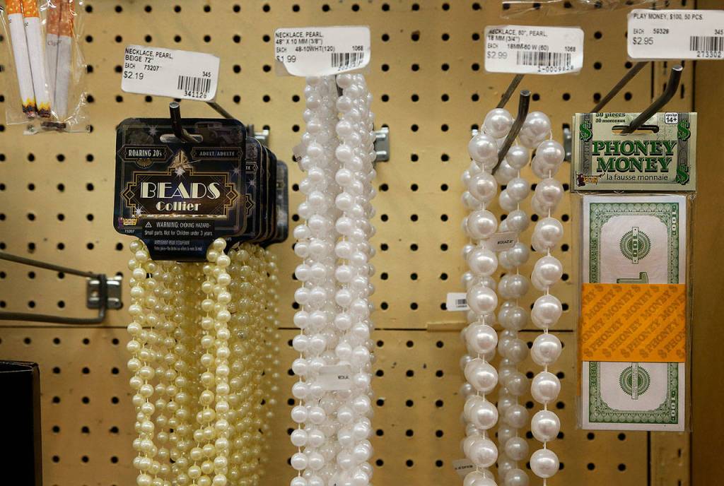 Fake cigarettes, faux pearls and phoney money. But the news is real as it gets. Display & Costumes Everett store is closing. (Dan Bates / The Herald)