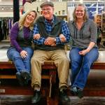 In Everett Monday, Display & Costume co-owner Dallas Carleton is joined on the stores big fabric-cutting table by his niece and manager of the Evertt store, Angie Durham (left) and his daughter Margaret McGowan (right). McGowan is the corporate manager of all the Display & Costume stores. The company is closing its Everett store. They will continue operation of their large store near Northgate in Seattle as well as their Issaquah store. (Dan Bates / The Herald)