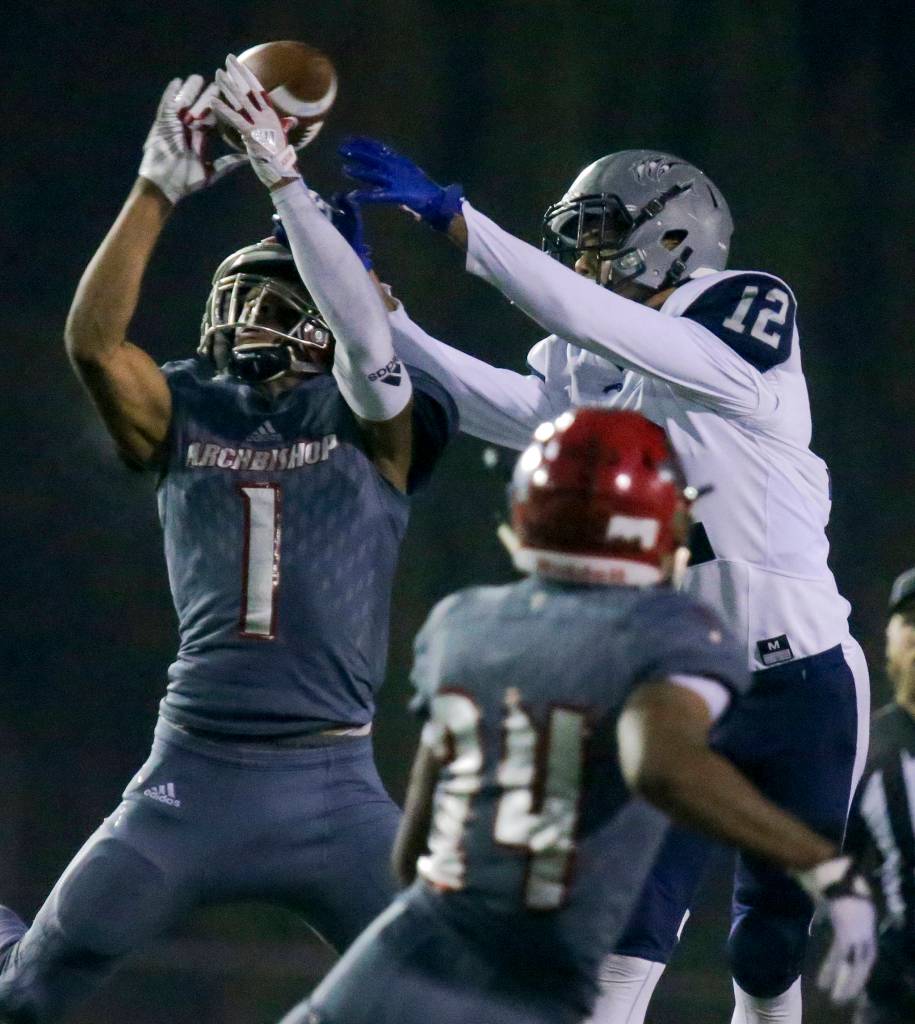 Archbishop Murphys Kyler Gordon (left) breaks up a pass intended for River Ridges Lamar Campbell as Archbishop Murphys Freddy Girault (24) looks on at Mariner High School on Nov. 10. (Kevin Clark / The Herald)