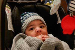 Five-month-old Felix Shope lies in his stroller ready to go home from the Snohomish County Courthouse with his new mom and dad, Alicia and Josh Shope of Edmonds. (Dan Bates / The Herald)