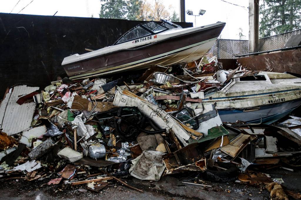 A boat sits atop a pile of trash at the Cathcart transfer station. (Ian Terry / The Herald)