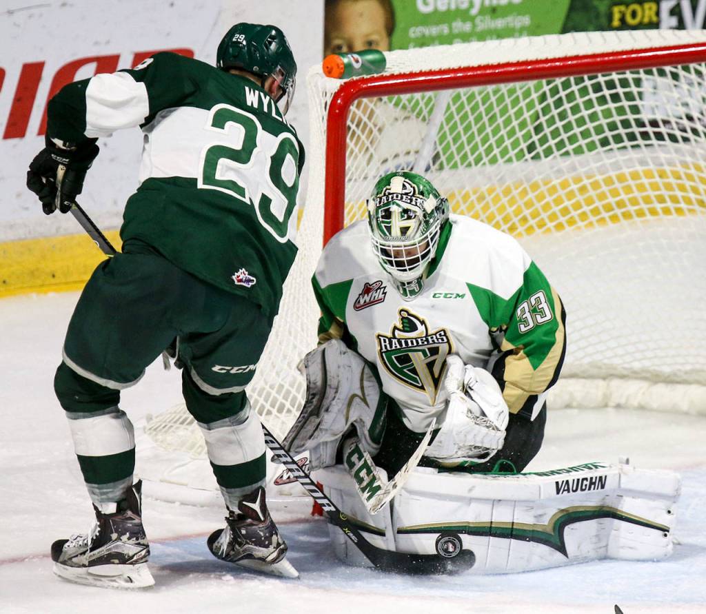 Everetts Wyatt Wylie works the puck in front of Prince Alberts Ian Scott during a game Nov. 15, 2017, at Xfinity Arena in Everett. (Kevin Clark / The Herald)