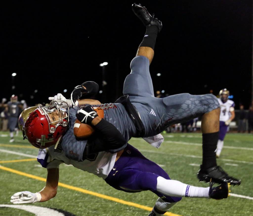 Archbishop Murphys Kyler Gordon makes a reception with North Kitsaps Josh Steakhouse defending at Veterans Memorial Stadium in Snohomish on Nov. 17. (Kevin Clark / The Herald)