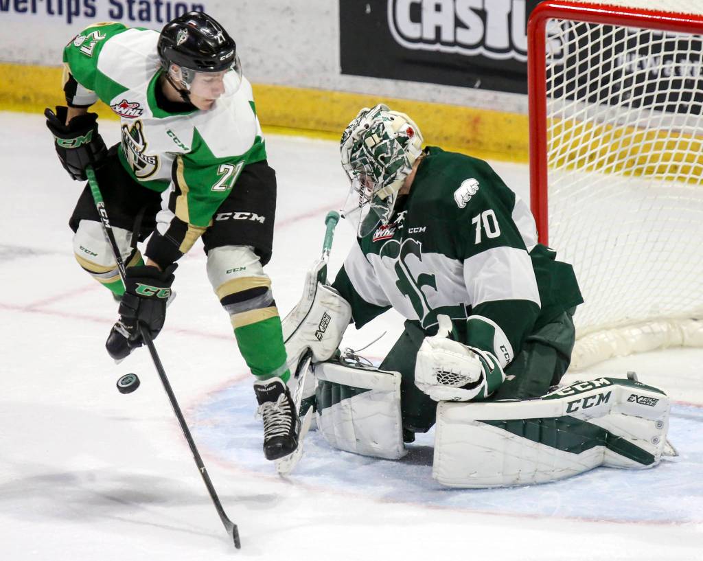 Prince Alberts Parker Kelly jumps to clear a shot with Everetts Carter Hart defending at Xfinity Arena in Everett on Nov. 15. (Kevin Clark / The Herald)