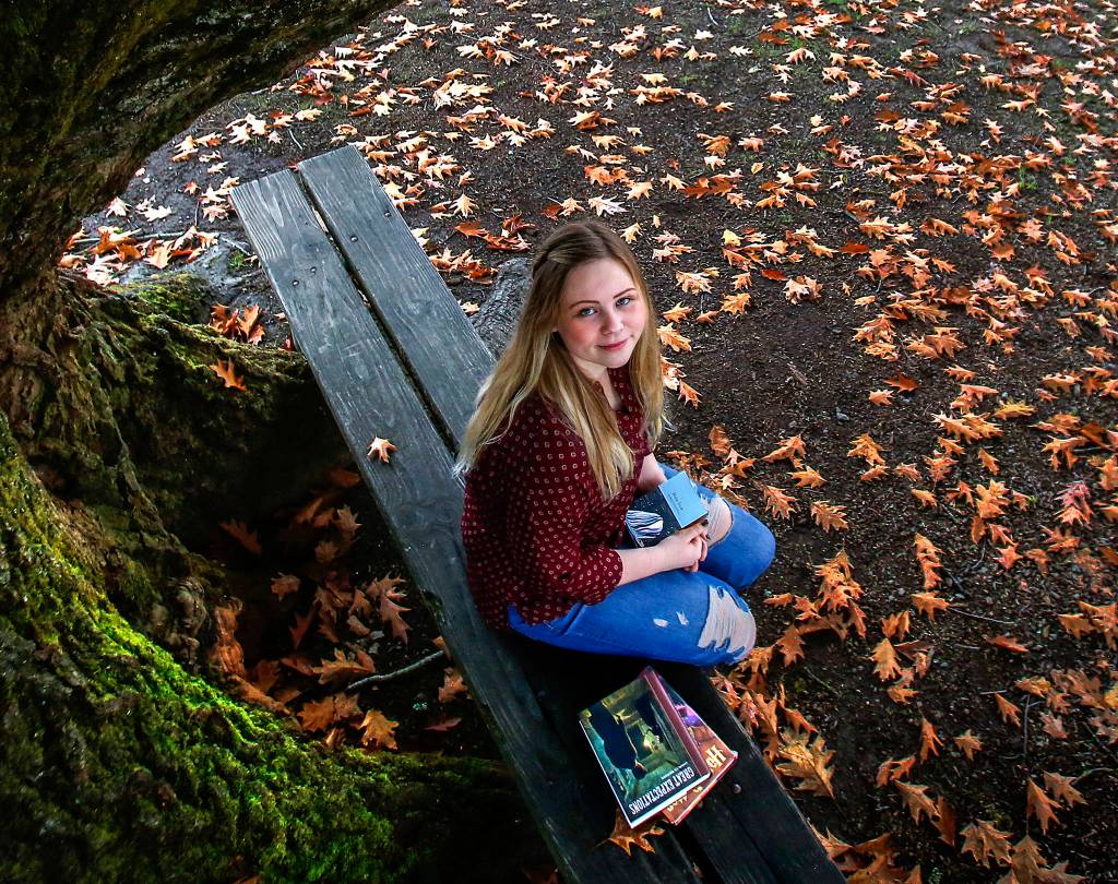 Isabelle Strehle, a senior at Snohomish High School, is helping build a library and is collecting book donations. (Dan Bates / The Herald)