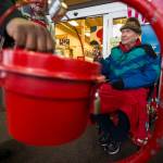 Salvation Army bell ringer Del Varney chats as a donor drops money into the bucket at the Fred Meyer store on Casino Road in Everett on Friday. (Andy Bronson / The Herald)