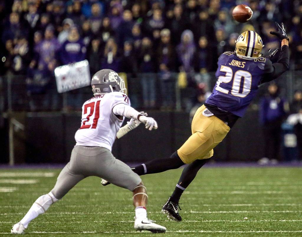 Washington Huskies wide receiver Ty Jones makes a catch with Washington State Cougars cornerback Marcellus Pippins trailing Saturday night during the 110th Apple Cup at Husky Stadium in Seattle November 25, 2017. Washington won 41-14. (Kevin Clark / The Herald)