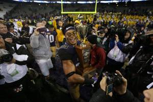 Washington Huskies defensive back Ezekiel Turner holds the Apple Cup trophy after the Washington State Cougars lost to the Washington Huskies 41-14 at Husky Stadium in the 110th Apple Cup on Saturday, Nov. 25, 2017 in Seattle, Wa. (Andy Bronson / The Herald)