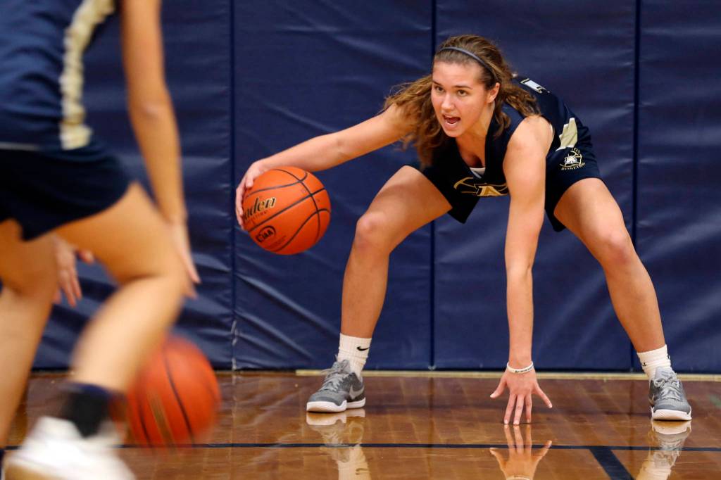 Peyton Brown works through a dribbling drill during practice at Arlington High in Arlington on Nov. 16. (Kevin Clark / The Herald)