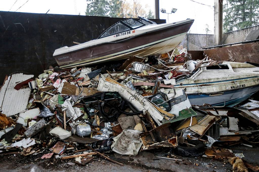 A boat sits atop a pile of trash at the Cathcart transfer station on Nov. 16. (Ian Terry / The Herald)