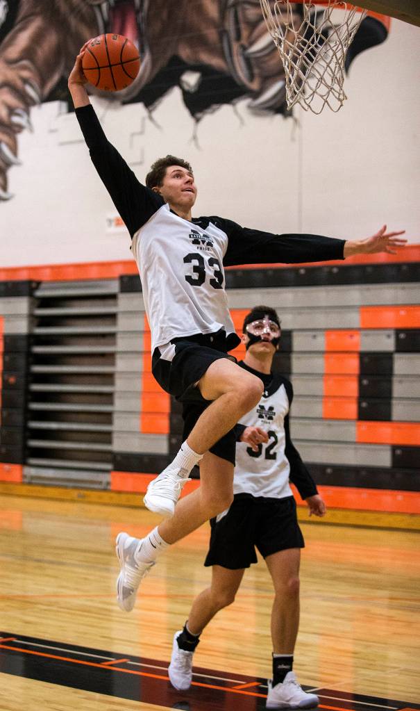 Monroe Highs Colby Kyle dunks the ball during practice Nov. 20 in Monroe. (Andy Bronson / The Herald)