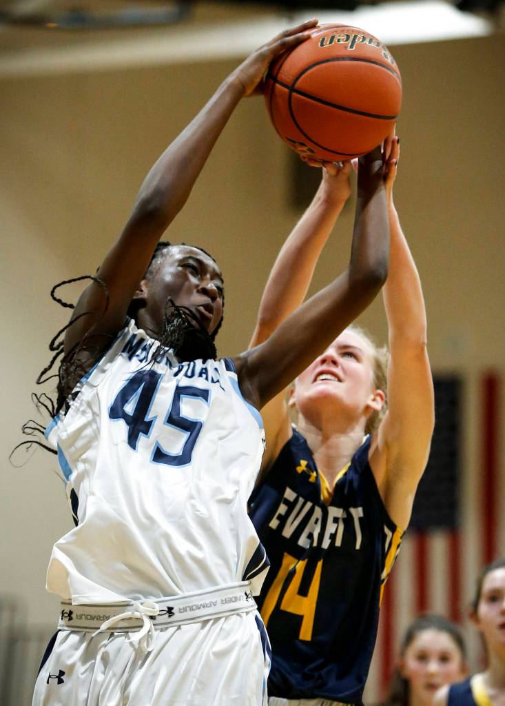 Meadowdales Fatoumata Jaiteh (45) snatches a rebound away from Everetts Kate Pohland (14) during a game Nov. 28, 2017, at Meadowdale High School in Lynnwood. (Ian Terry / The Herald)