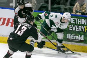 Everetts Matt Fonteyne, right, controls the puck with Vancouvers Alex Kannok Leipert, left, and Vancouvers Tyler Popowich giving chase in the first period Friday night at Angels of the Winds Arena in Everett on December 29, 2017. (Kevin Clark / The Daily Herald)