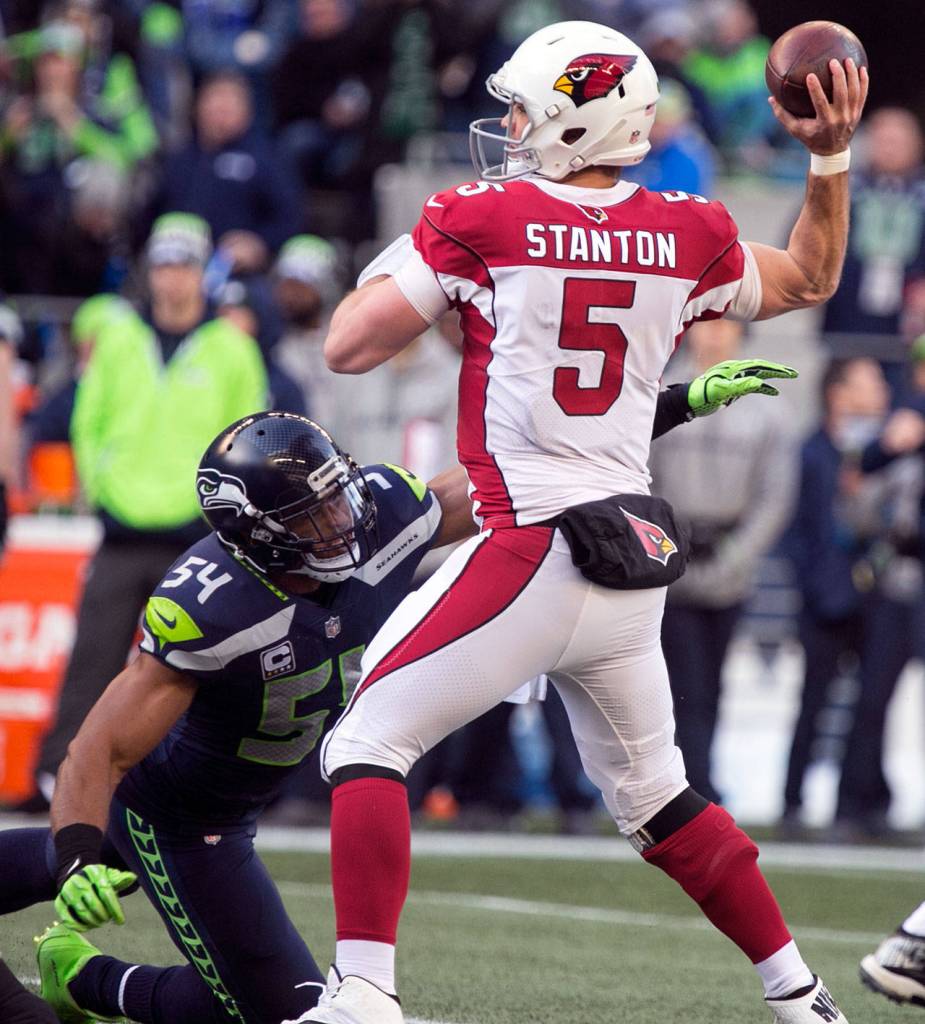 Cardinals quarterback Drew Stanton stands tall with Seahawks linebacker Bobby Wagner pass rushing Sunday afternoon at CenturyLink Field in Seattle on December 31, 2017. Seattle lost 26-24. (Kevin Clark / The Daily Herald)