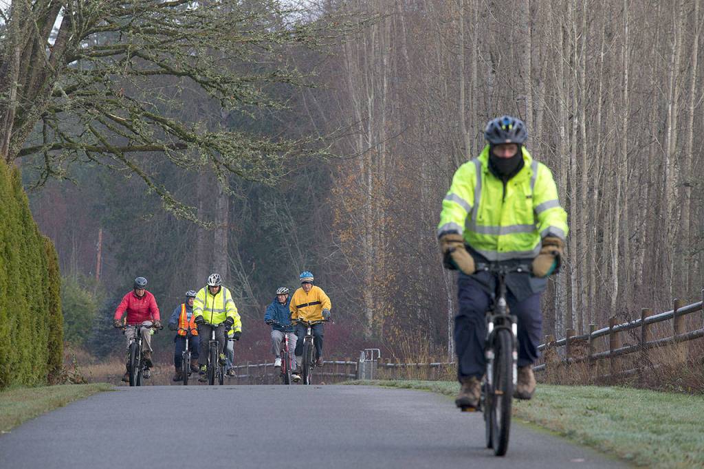 Dressed for temperatures in the 30s, Jack Wilson pulls ahead of the group as the cyclists bike from Arlington to Lake Cassidy via the Centennial Trail on Dec. 4 in Arlington. (Andy Bronson / The Herald)