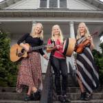 Out in front of the Thumbnail Theater in Snohomish, the sisters from left, Greta, Solana and Willow pause before a concert there. (Kevin Clark / The Herald)
