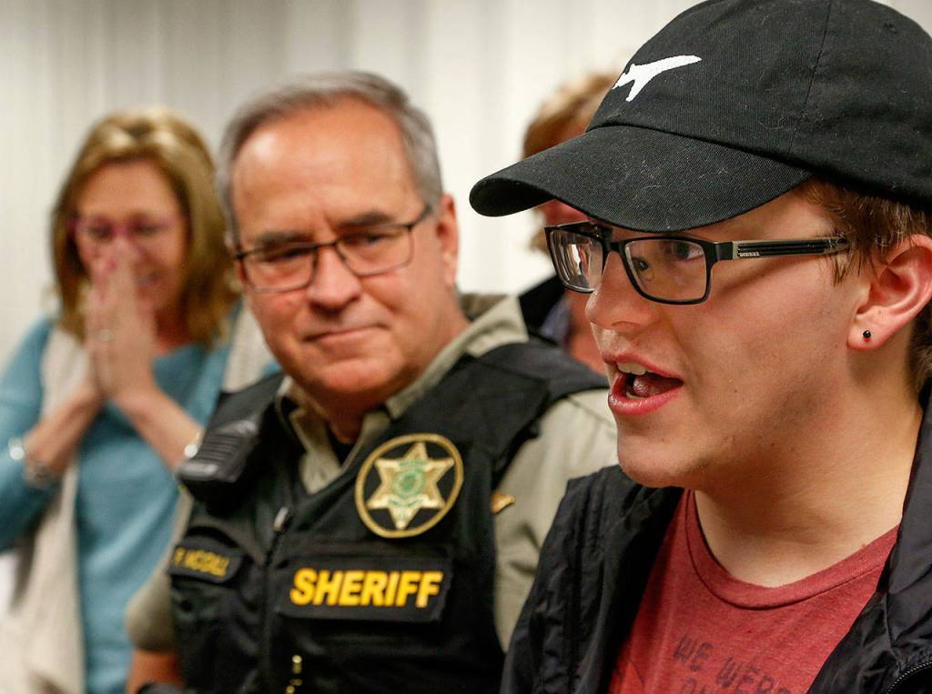 Parker Langs best friend, Logan McGill, 20, talks about Parker with friends, his father, Patrick McGill (center) and Parkers mom, Vicki Moore (left), who responds with delight to some of his comments. (Dan Bates / The Herald)
