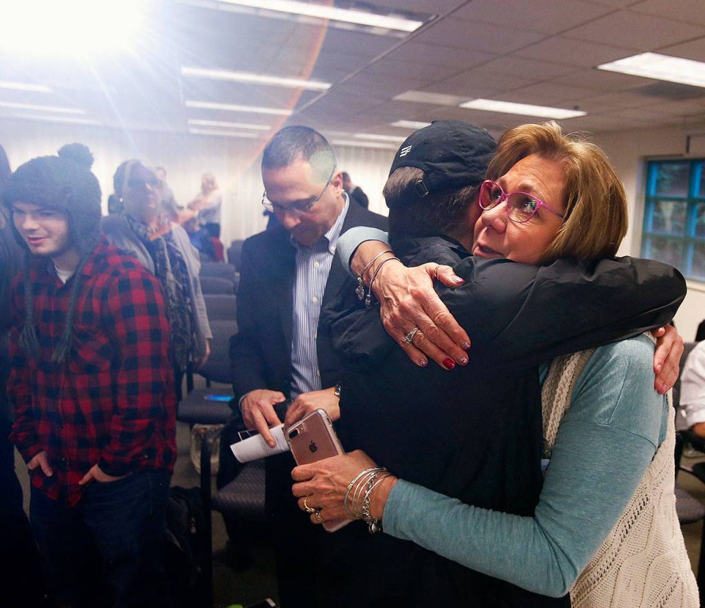 Parker Langs mom, Vicki Moore hugs her sons best friend, Logan McGill, 20 as Thursdays event nears an end. McGill had contributed a short movie and slide show that portrayed Parkers upbeat personality and joy he shared with others. (Dan Bates / The Herald)