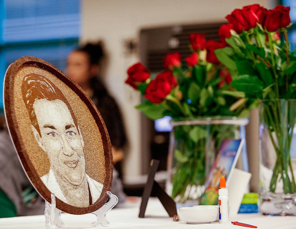 The floragraph of Parkers image (left) is made of seeds and other natural materials. The eyebrows are left unfinished so his mom, Vicki Moore and others close to her can finish it before it goes to Pasadena, California, to adorn the Donate Life Rose Parade Float. (Dan Bates / The Herald)