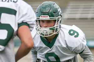 Noah Becker, defensive back, eyes the ball held by Jack Kramer during drills Wednesday afternoon at Edmonds-Woodway High School in Edmonds on October 11th, 2017. (Kevin Clark / The Herald)