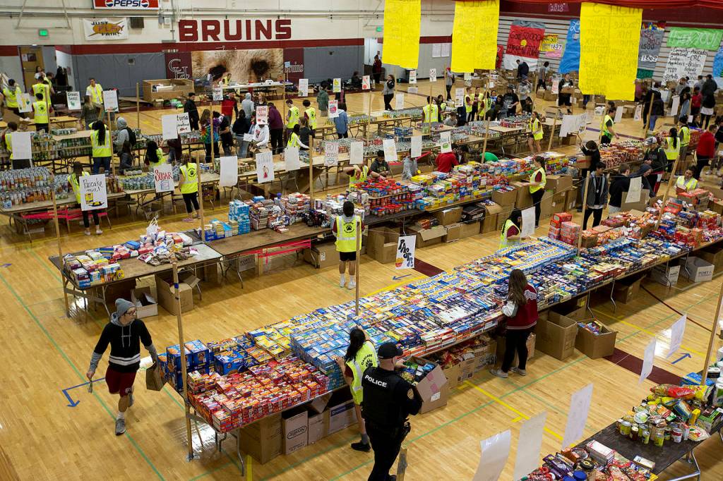 Hundreds of students help sort and collect donations at Cascade High Schools annual food drive on Wednesday. (Ian Terry / The Herald)