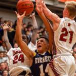 Everetts Elijah Ross-Rutter attempts a shot over Cascades Musa Baldeh (left) and Cascades Nicholas Klemp on Friday night at Everett Community College. (Kevin Clark / The Herald)