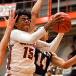 Cascades Donelle Meriwether attempts a shot over Everetts Elijah Ross-Rutter on Friday night at Everett Community College. (Kevin Clark / The Herald)