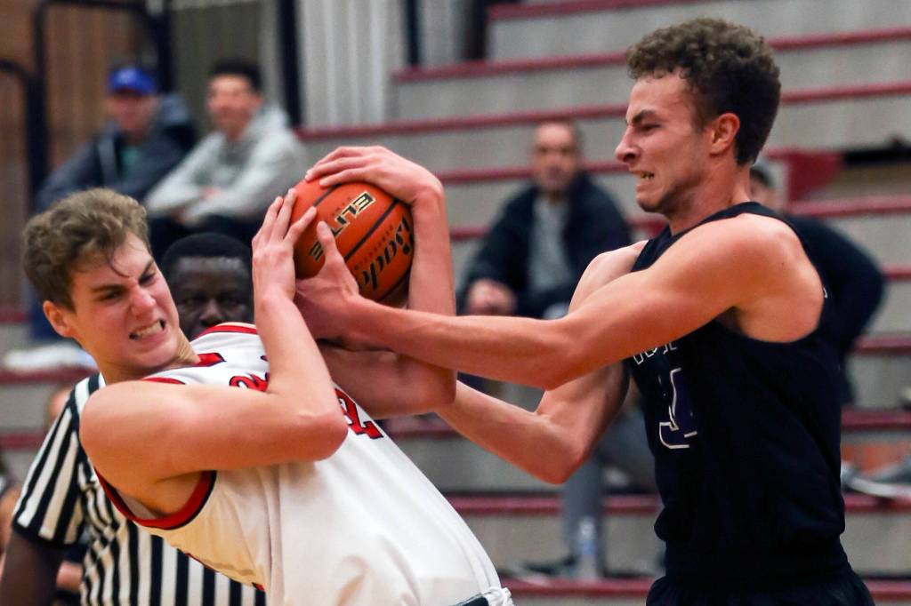 Mountlake Terrances Akol Yel (left) and Kamiaks Braden Leary are tied up at Mountlake Terrace High School on Nov. 29. (Kevin Clark / The Herald)