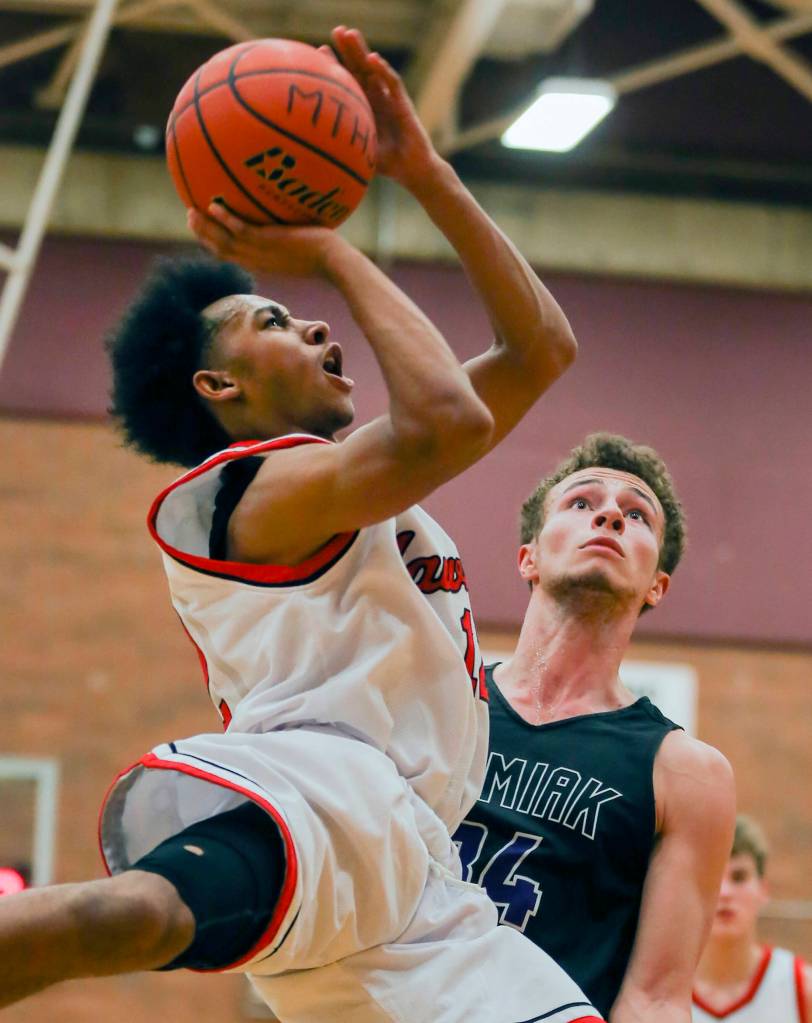Mountlake Terrances Connor Williams (left) attempts a shot with Kamiaks Daniel Sharpe looking on at Mountlake Terrace High School on Nov. 29. (Kevin Clark / The Herald)