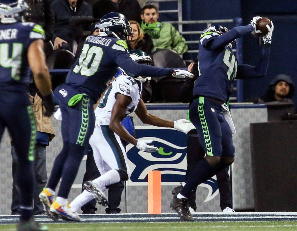 Seahawks Bryon Maxwell makes an interception to seal the win agains the Eagles Sunday night at CenturyLink Field in Seattle on December 3, 2017. Seattle won 24-10. (Kevin Clark / The Herald)